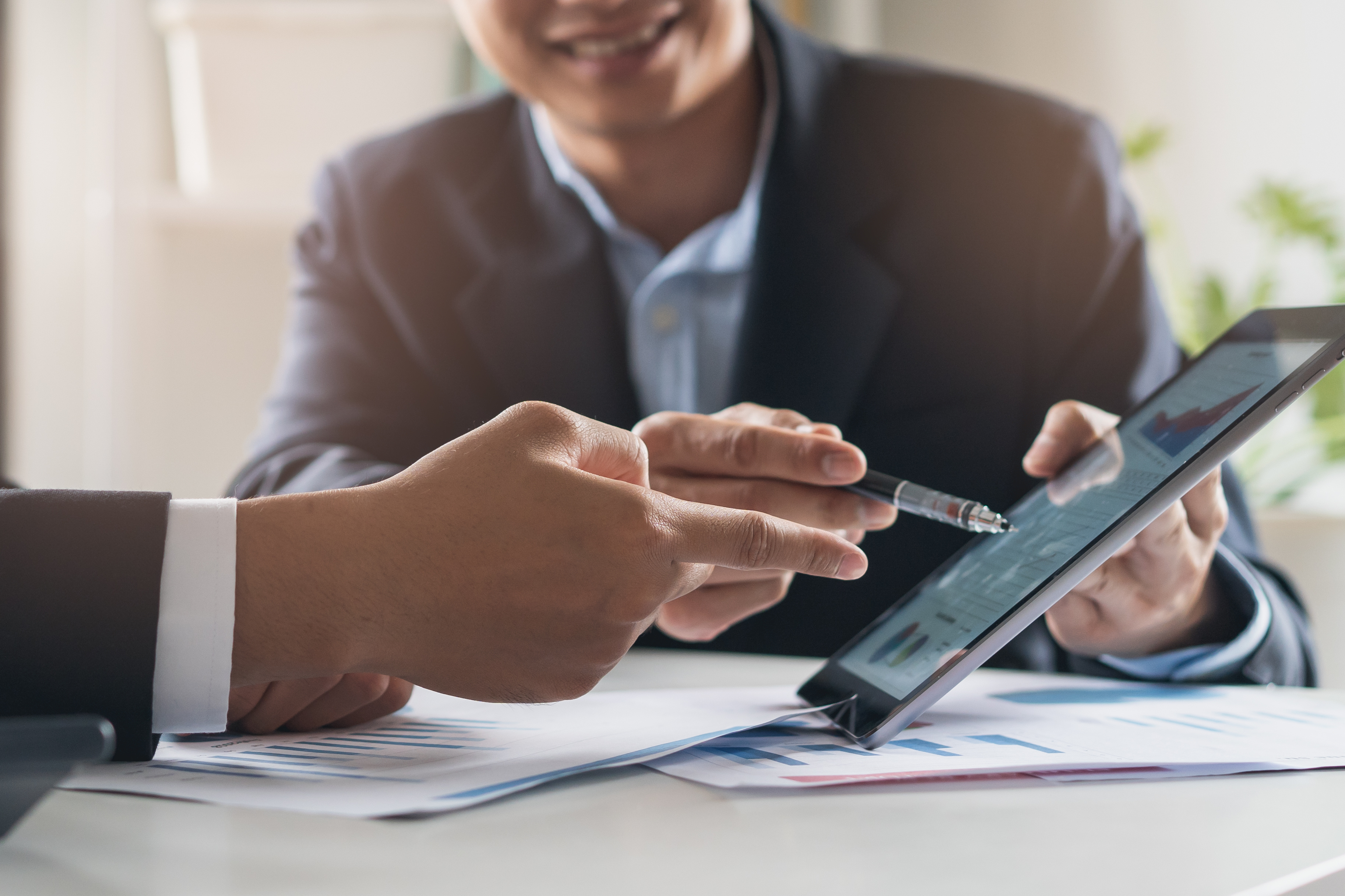 Financial consultant showing investment plan on a tablet