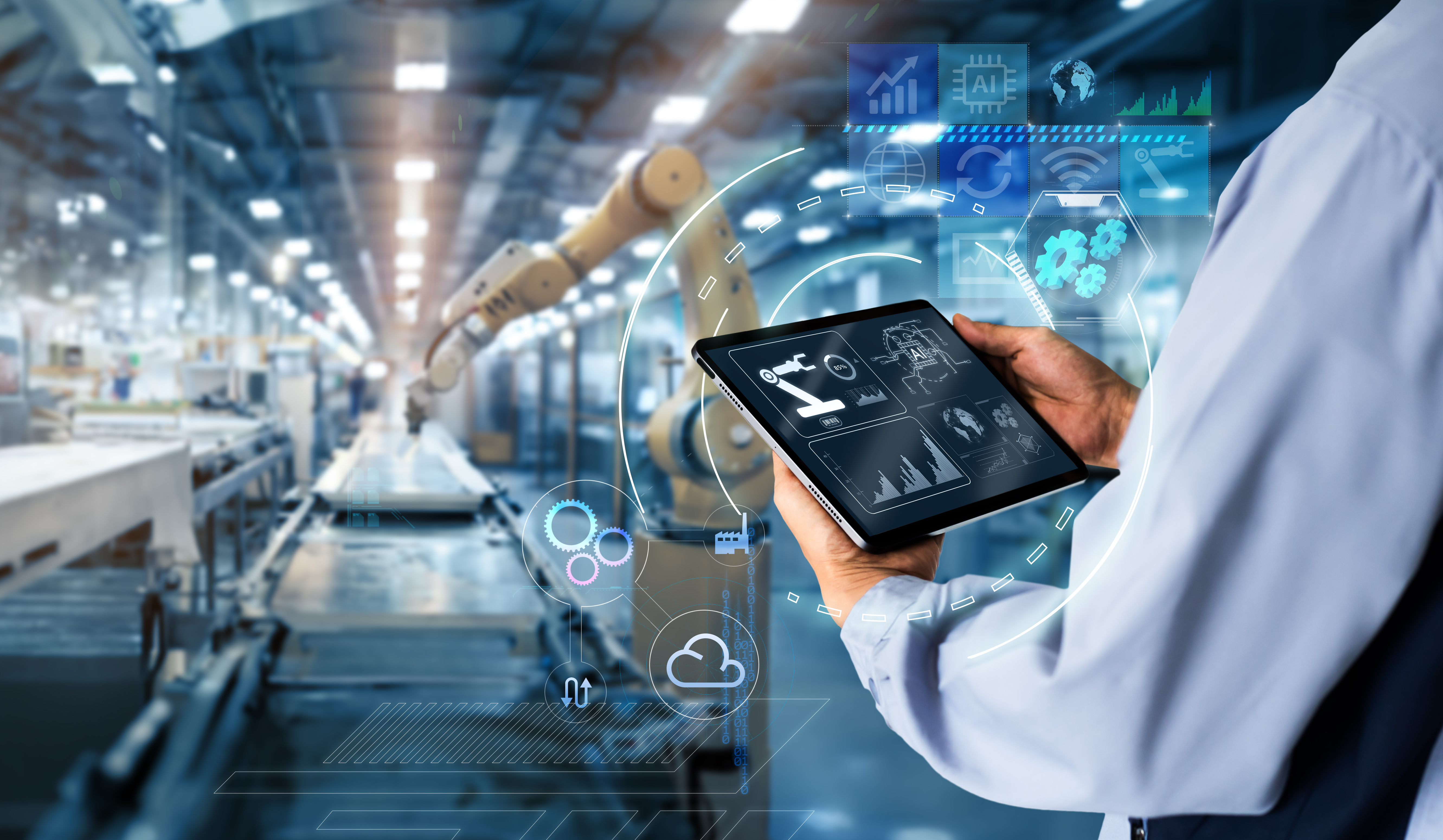 hands holding a tablet on blurred automation machine as background to illustrate smart industry control