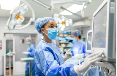 anesthesist checking monitor while sedating patient